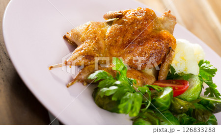 Tobacco quail with vegetable garnish 126833288