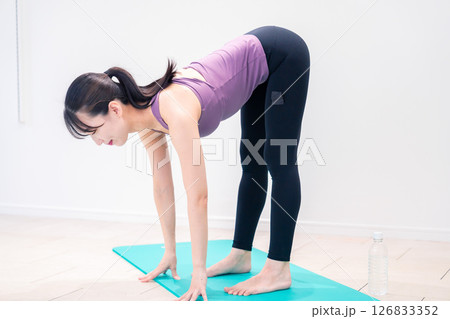 ジムでヨガコーチをするスポーティーな女性 126833352