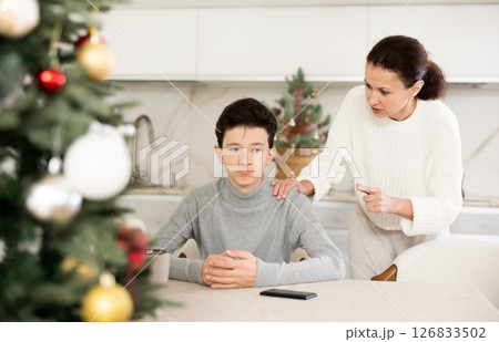 Mother scolds her son for inappropriate behavior on Christmas holiday Mother scolds her son for inappropriate behavior on Christmas holiday 126833502