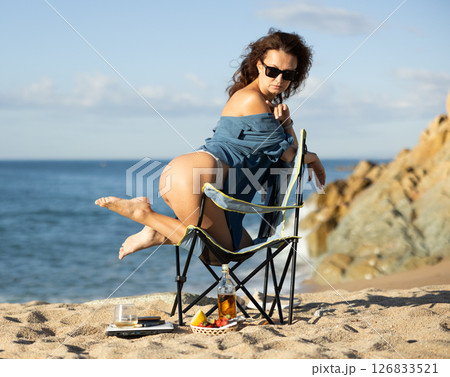 Gorgeous topless semi-nude businesswoman in jacket posing on beach 126833521