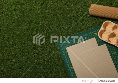 Drawing and paper materials for upcycling on green background, space for text 126833586