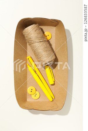 Paper box with twine, scissors and pens on white background, top view 126833587