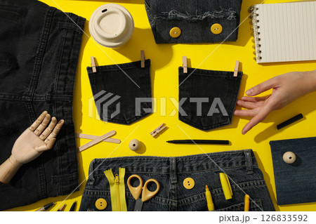 Tools, materials for upcycling and hand on yellow background, top view Tools, materials for upcycling and hand on yellow background, top view 126833592