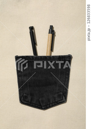 Denim pocket with pens on light background, top view Denim pocket with pens on light background, top view 126833598