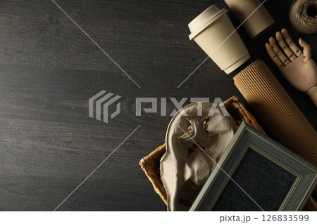 Wooden hand, paper cup and materials for upcycling on wooden background, space for text Wooden hand, paper cup and materials for upcycling on wooden background, space for text 126833599