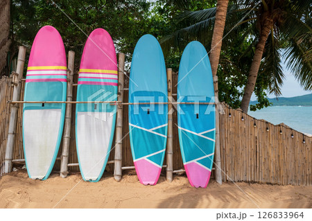 surfboard of resort by bamboo wall and coconut tree, Pattaya 126833964