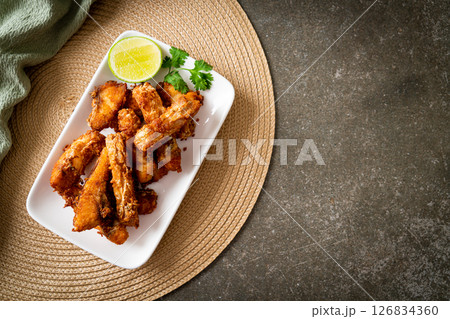 Fried Snapper Belly on white plate Fried Snapper Belly on white plate 126834360
