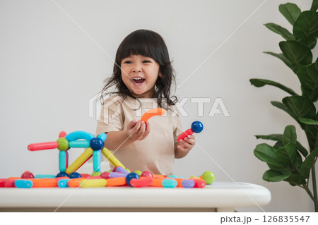 toddler girl playing colorful magnetic construction toy toddler girl playing colorful magnetic construction toy 126835547
