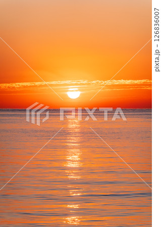 Beautiful red and orange sunrise over the sea. Beautiful red and orange sunrise over the sea. 126836007