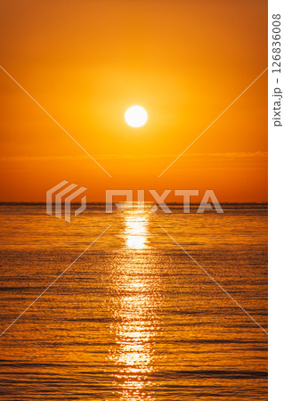 Beautiful red and orange sunrise over the sea. Beautiful red and orange sunrise over the sea. 126836008