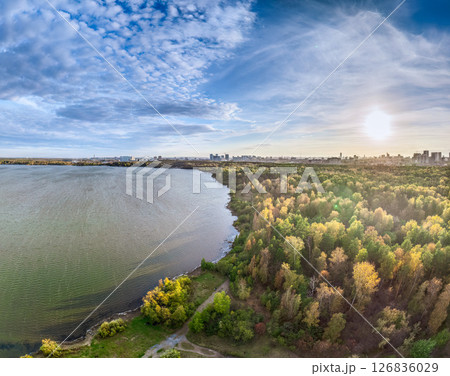Autumn forest on lake shore at sunset and city on horizon, auerial view Autumn forest on lake shore at sunset and city on horizon, auerial view 126836029