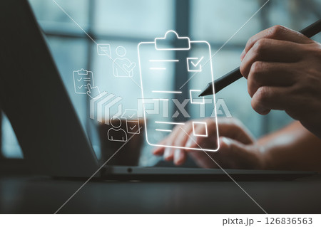 Task Management Software Concept with Stylus Writing on Virtual Checklist Over Laptop 126836563