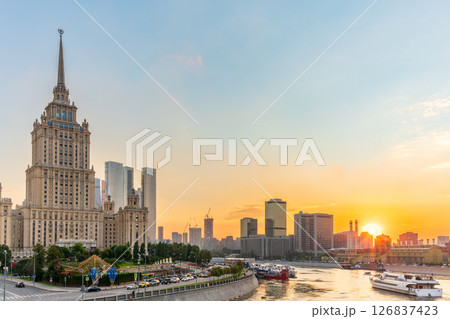 High-rise stalinist building near river at summer sunset in Moscow, Russia. Historic name is Hotel Ukraine. 126837423