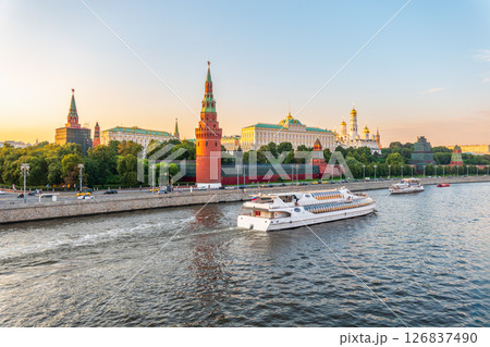 View of Kremlin with Vodovzvodnaya tower, Grand Kremlin Palace from repaired Bolshoy Kamenny Bridge in Moscow city on sunny summer day. Cruise ship sails on the Moscow river View of Kremlin with Vodovzvodnaya tower, Grand Kremlin Palace from repaired Bolshoy Kamenny Bridge in Moscow city on sunny summer day. Cruise ship sails on the Moscow river 126837490