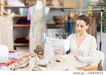 Woman tailor at work in cloth design shop 126839417