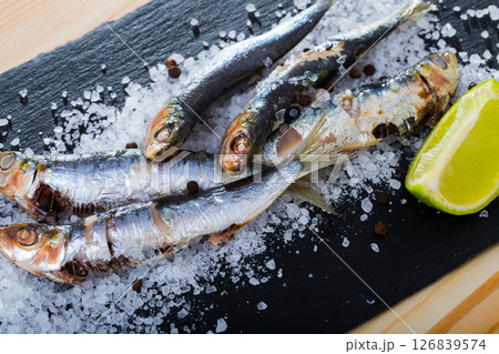 Baked sardines on sea salt Baked sardines on sea salt 126839574