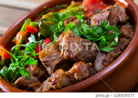 Tasty dish ghiveci of bulgarian cuisine of beef with paprika at clay pot Tasty dish ghiveci of bulgarian cuisine of beef with paprika at clay pot 126839575