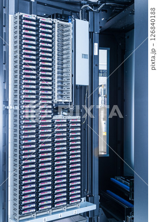 cluster of hard drives stacked inside data storage cabinet 126840188