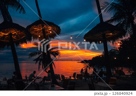 Palm Trees on White Sandy Beach with Island View in Azure Sea 126840924