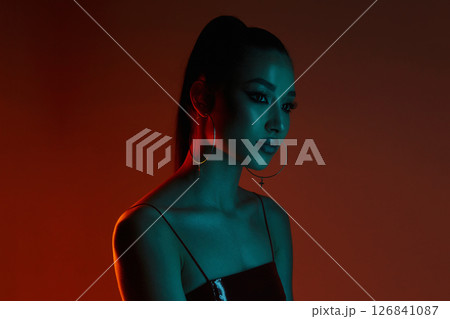beautiful young woman in color lights 126841087