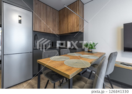 L-Shaped Kitchen with Dining Table and TV Area L-Shaped Kitchen with Dining Table and TV Area 126841330