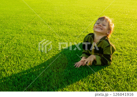 The child goes in for sports at the stadium. The boy training before playing football. 126841916