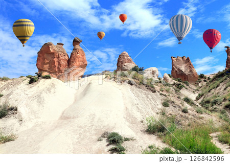 Balloon flight, famous tourist attraction of Cappadocia. Air balloons and Camel rock at Devrent valley (Imaginary valley), Cappadocia, Turkey. Topic of vacation, travel, trip abroad, cruises and tours Balloon flight, famous tourist attraction of Cappadocia. Air balloons and Camel rock at Devrent valley (Imaginary valley), Cappadocia, Turkey. Topic of vacation, travel, trip abroad, cruises and tours 126842596