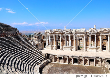 Top view on theater in ancient Hierapolis, Pamukkale, Anatolia, Turkey. Topic of vacation, travel, trip abroad, cruises and tours. Complex is a prominent symbol of Turkey and a key tourist attraction Top view on theater in ancient Hierapolis, Pamukkale, Anatolia, Turkey. Topic of vacation, travel, trip abroad, cruises and tours. Complex is a prominent symbol of Turkey and a key tourist attraction 126842603