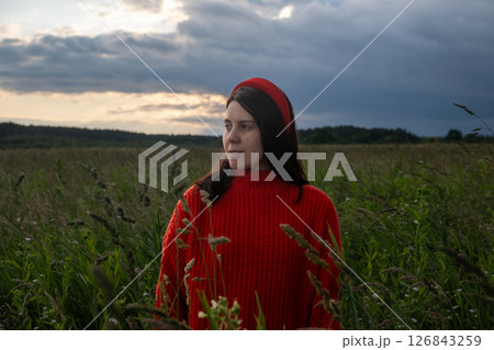 Woman in Red Sweater in Grassy Field 126843259