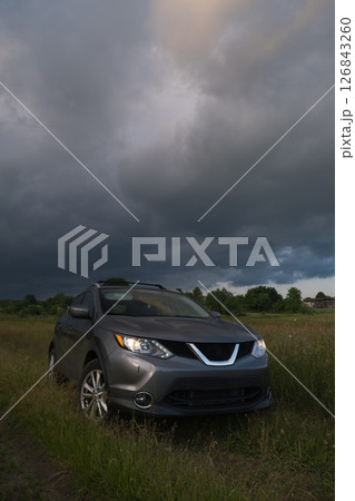 SUV in a Field Under Dramatic Skies SUV in a Field Under Dramatic Skies 126843260