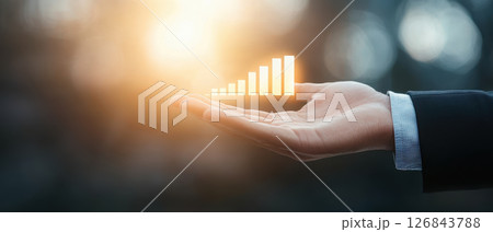 Hand holding glowing growth bar symbolizing business success and progress 126843788