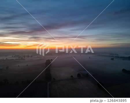 Each and every morning, a serene and beautiful sunrise over the misty fields awaits you Each and every morning, a serene and beautiful sunrise over the misty fields awaits you 126843895