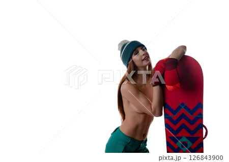 Woman modeling lingerie while holding a snowboard in a minimalistic setting Woman modeling lingerie while holding a snowboard in a minimalistic setting 126843900