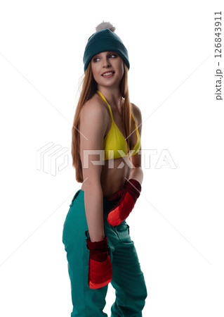 Woman models colorful lingerie with winter accessories, highlighting style Woman models colorful lingerie with winter accessories, highlighting style 126843911
