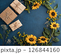 父の日をイメージした深いブルーの背景。ギフトボックスとリボン。花。ギフト。感謝。愛情を伝えるイメージ 126844160