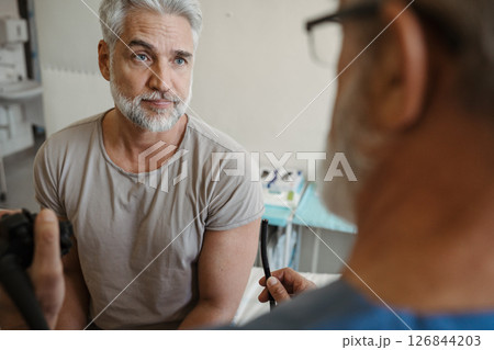 Doctor explaining gastroscopy procedure on patient. Examination of upper digestive tract. 126844203