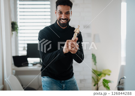 Happy man proudly holding a trophy. 126844288