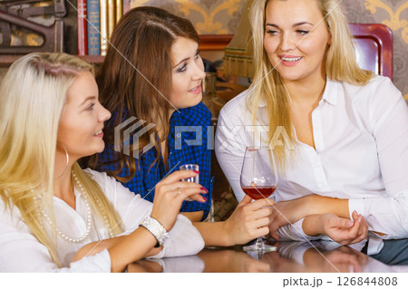 Girls in pub club gossiping and talking 126844808