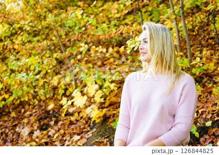 Blonde woman relaxing in autumn park 126844825