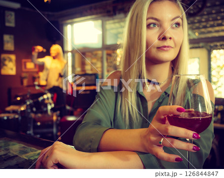 Girl with alcohol glass in pub club Girl with alcohol glass in pub club 126844847