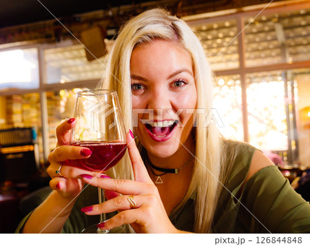 Girl with alcohol glass in pub club 126844848