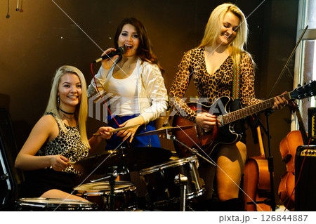Woman singing, band playing instruments. Woman singing, band playing instruments. 126844887