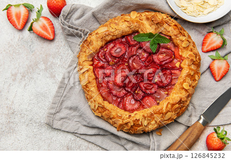 Delicious homemade strawberry galette with almond petals and fresh mint 126845232