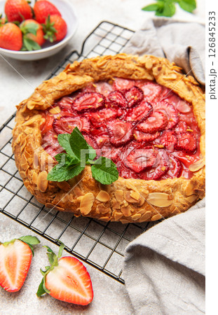 Delicious homemade strawberry galette cooling on wire rack 126845233