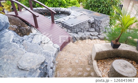 Modern Stone Garden Pathway with Wooden Bridge and Outdoor Jacuzzi 126845967