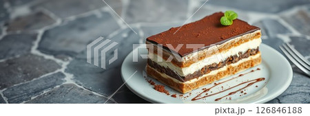 Delicious layered dessert with chocolate and cream served on a white plate 126846188