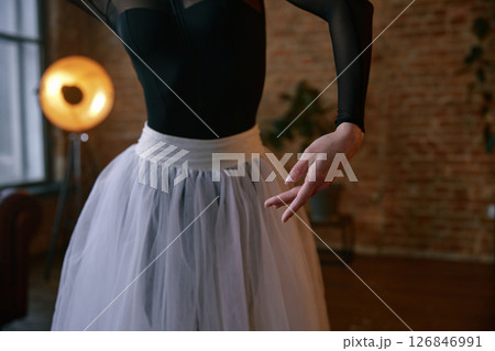 Elegant female dancer in an artistic pose set against a striking urban background Elegant female dancer in an artistic pose set against a striking urban background 126846991