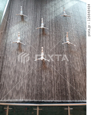 Waterfall with flying men in Dubai Mall in Dubai, United Arab Emirates. Travel attraction. 126848484