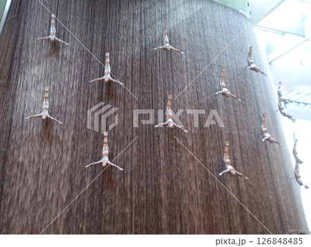 Waterfall with flying men in Dubai Mall in Dubai, United Arab Emirates. Travel attraction. 126848485
