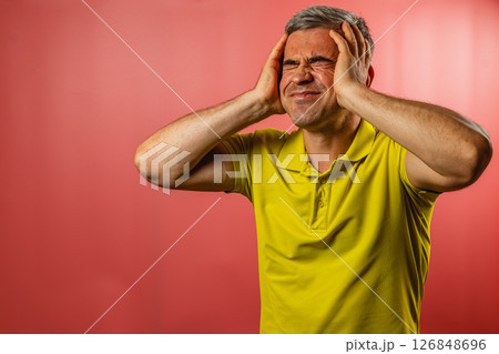 Man shows frustration with a pained expression in bright setting 126848696